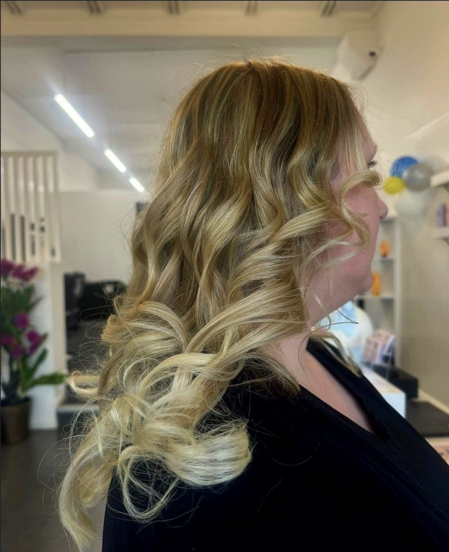 Soft blonde waves, side view, inside the Nova salon
