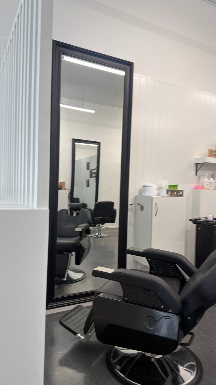 Tall black-framed mirror and reclining chair