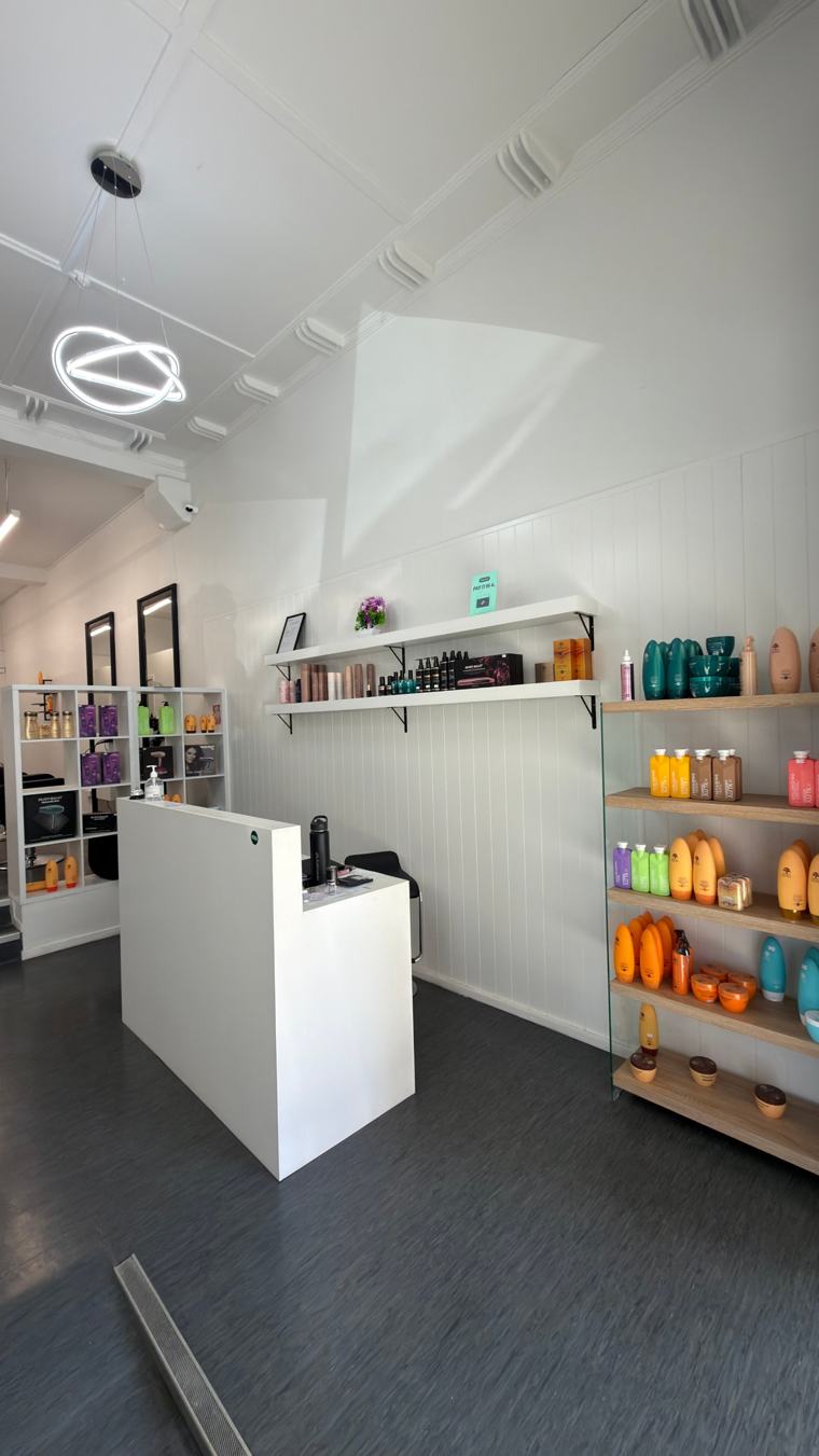 Reception desk with product shelves and a ring pendant light